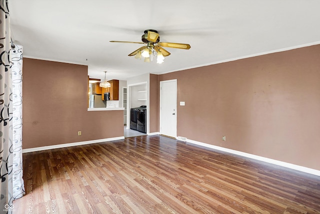 3302 Beech Dr, Columbus, IN 47203 - unfurnished living room featuring ceiling fan, wood finished floors, and crown molding