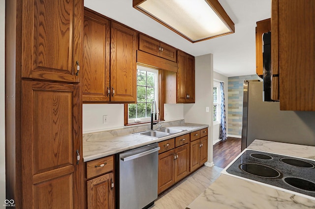 3302 Beech Dr, Columbus, IN 47203 - kitchen featuring appliances with stainless steel finishes, brown cabinetry, and light marble finish flooring