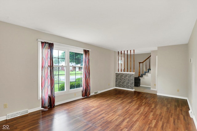 3302 Beech Dr, Columbus, IN 47203 - unfurnished living room with wood finished floors and stairway