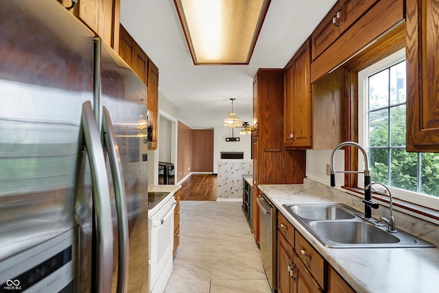 3302 Beech Dr, Columbus, IN 47203 - kitchen with stainless steel appliances, brown cabinets, and decorative light fixtures