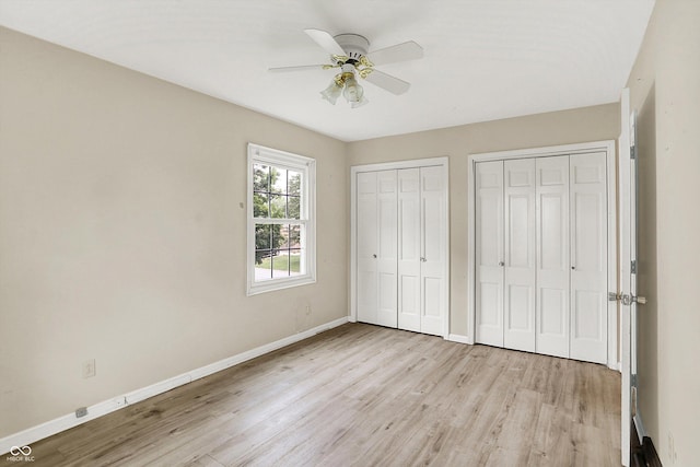 3302 Beech Dr, Columbus, IN 47203 - unfurnished bedroom with two closets, light wood-style floors, and ceiling fan