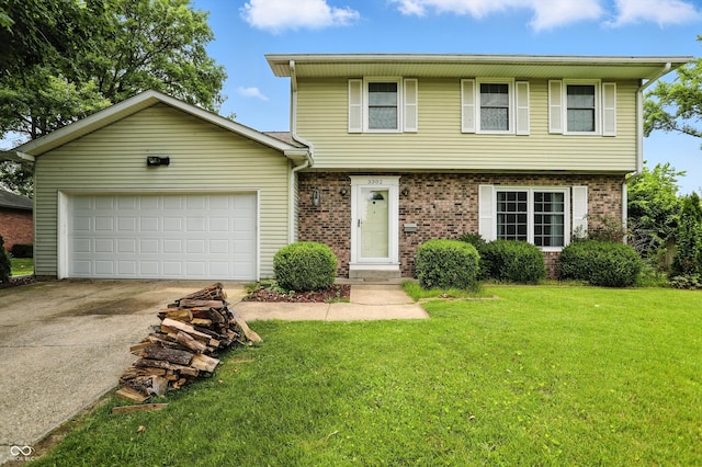3302 Beech Dr, Columbus, IN 47203 - colonial home with driveway, an attached garage, a front lawn, and brick siding