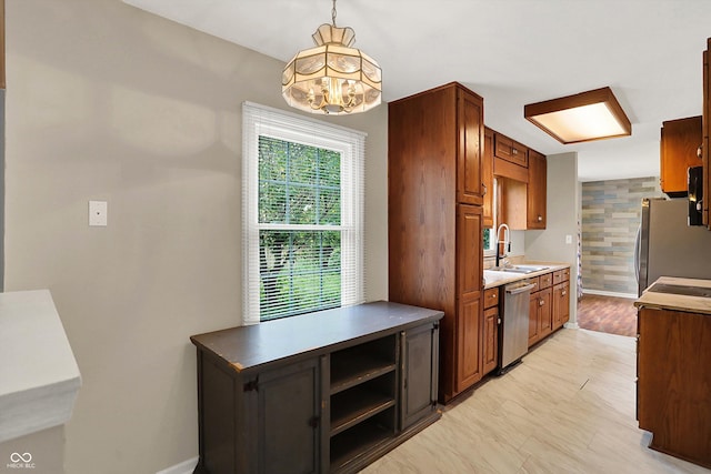 3302 Beech Dr, Columbus, IN 47203 - kitchen with stainless steel appliances, a chandelier, brown cabinets, and pendant lighting