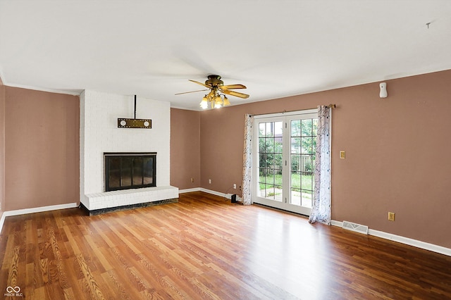 3302 Beech Dr, Columbus, IN 47203 - unfurnished living room featuring wood finished floors, a ceiling fan, and a fireplace