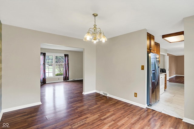 3302 Beech Dr, Columbus, IN 47203 - unfurnished room with a chandelier and wood finished floors