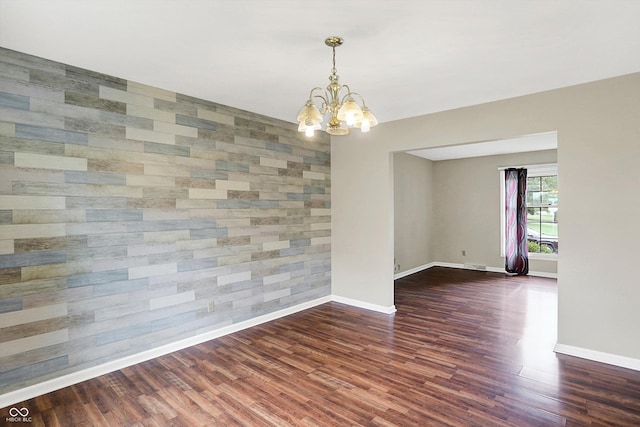 3302 Beech Dr, Columbus, IN 47203 - spare room featuring a chandelier, wood finished floors, and an accent wall