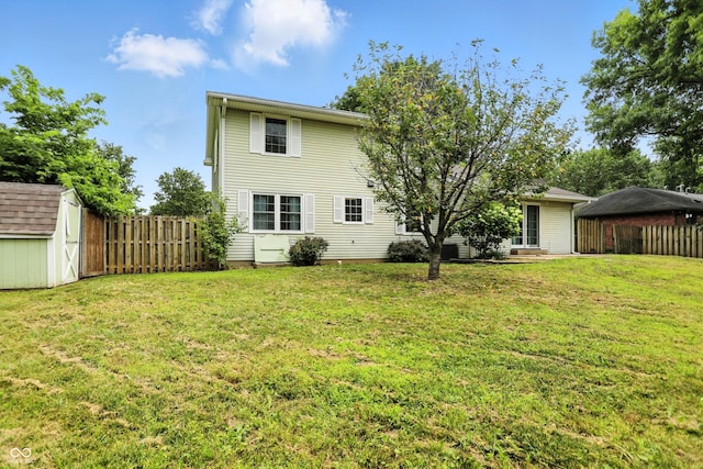 3302 Beech Dr, Columbus, IN 47203 - back of house with a storage unit and a fenced backyard