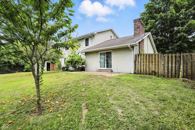 3302 Beech Dr, Columbus, IN 47203 - rear view of house with a chimney, a patio area, and an outbuilding