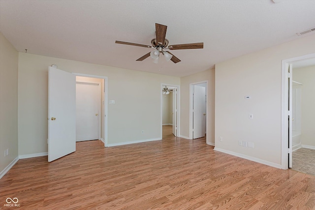 3183 Hemlock St, Whiteland, IN 46184 - unfurnished bedroom featuring a walk in closet, light wood-type flooring, ceiling fan, a closet, and ensuite bathroom