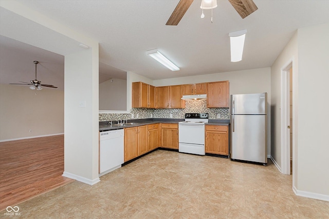 3183 Hemlock St, Whiteland, IN 46184 - kitchen with white appliances, ceiling fan, under cabinet range hood, dark countertops, and backsplash