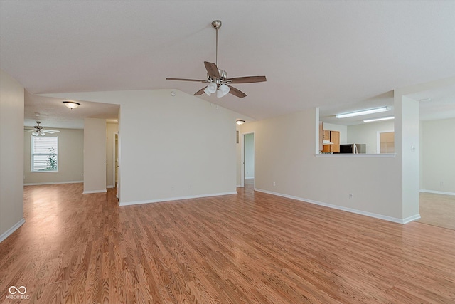 3183 Hemlock St, Whiteland, IN 46184 - unfurnished living room featuring ceiling fan, light wood-type flooring, and vaulted ceiling