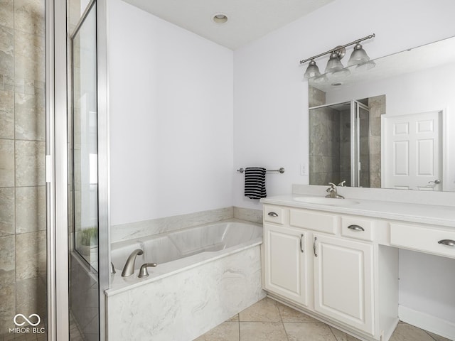 6730 Spirit Lake Dr Unit 202, Indianapolis, IN 46220 - full bathroom featuring vanity, a garden tub, a stall shower, and tile patterned flooring