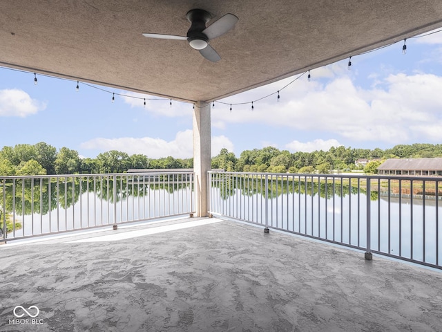 6730 Spirit Lake Dr Unit 202, Indianapolis, IN 46220 - patio / terrace featuring a water view, ceiling fan, and view of wooded area