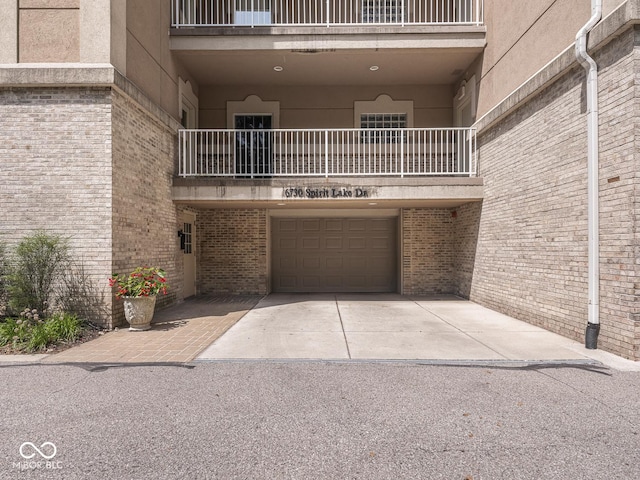 6730 Spirit Lake Dr Unit 202, Indianapolis, IN 46220 - view of property with a garage and driveway