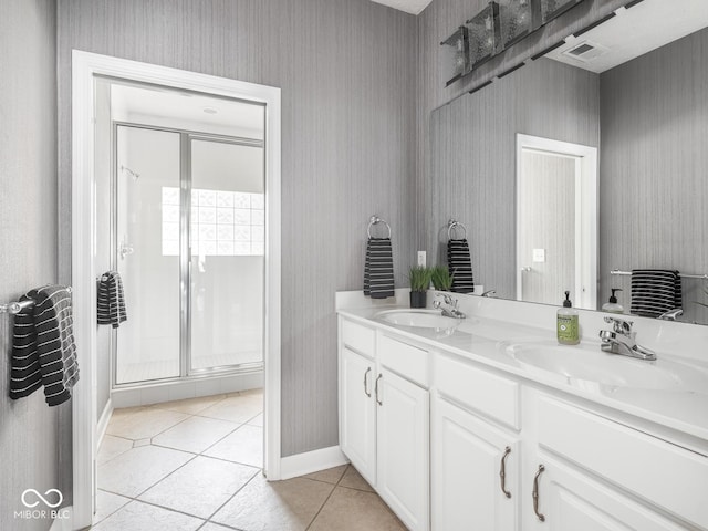 6730 Spirit Lake Dr Unit 202, Indianapolis, IN 46220 - bathroom featuring tile patterned floors, a shower stall, double vanity, and wallpapered walls