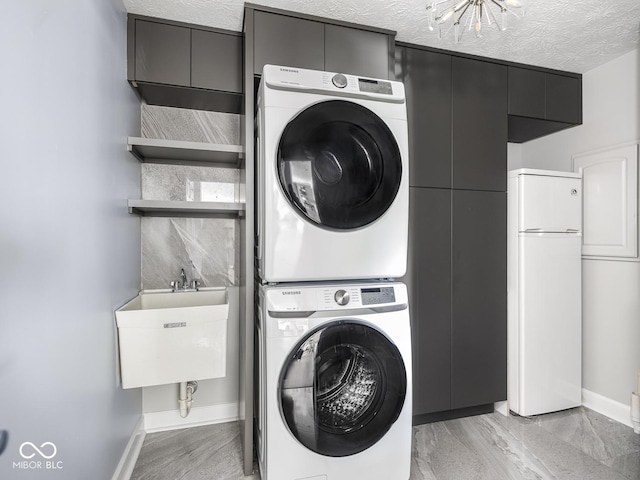 6730 Spirit Lake Dr Unit 202, Indianapolis, IN 46220 - laundry area with stacked washer / dryer and cabinet space