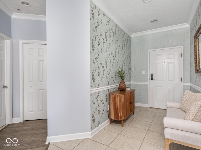 6730 Spirit Lake Dr Unit 202, Indianapolis, IN 46220 - tiled foyer featuring wallpapered walls, ornamental molding, and a textured ceiling