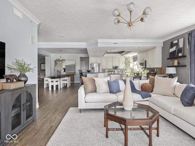 6730 Spirit Lake Dr Unit 202, Indianapolis, IN 46220 - living room with a chandelier, wood finished floors, crown molding, and a textured ceiling