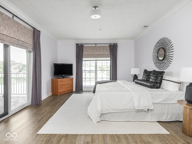 6730 Spirit Lake Dr Unit 202, Indianapolis, IN 46220 - bedroom featuring crown molding, wood finished floors, access to outside, and a textured ceiling