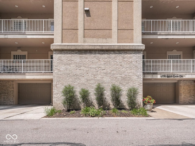 6730 Spirit Lake Dr Unit 202, Indianapolis, IN 46220 - view of building exterior with a garage and driveway