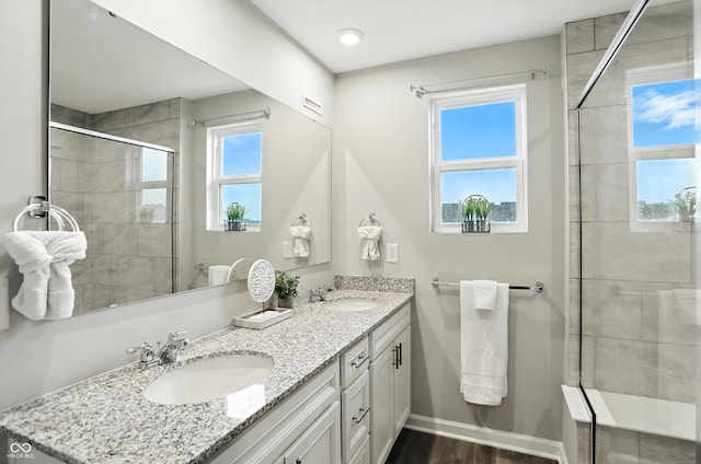 18750 Terra Vis Pl, Westfield, IN 46074 - full bath featuring double vanity, a tile shower, and wood finished floors
