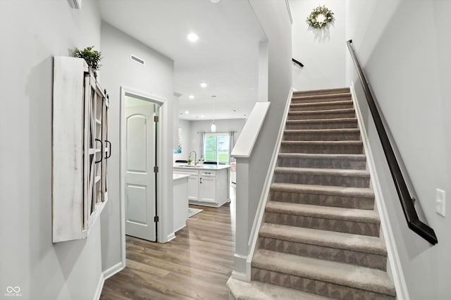 18750 Terra Vis Pl, Westfield, IN 46074 - stairway featuring wood finished floors and recessed lighting