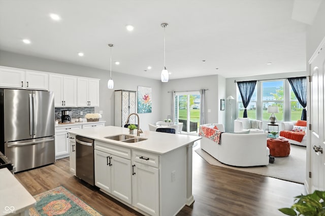 18750 Terra Vis Pl, Westfield, IN 46074 - kitchen featuring stainless steel appliances, open floor plan, dark wood finished floors, light countertops, and recessed lighting