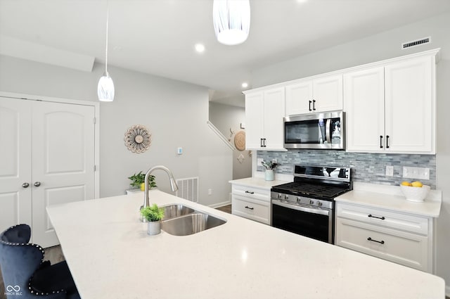 18750 Terra Vis Pl, Westfield, IN 46074 - kitchen with appliances with stainless steel finishes, tasteful backsplash, pendant lighting, light countertops, and recessed lighting