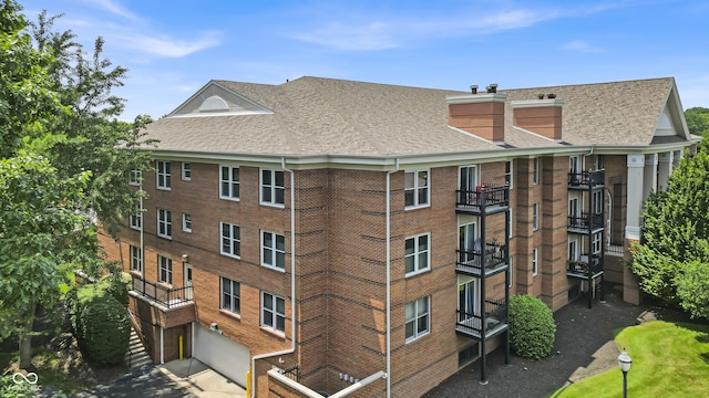 8650 Jaffa Ct W Drive 32, Indianapolis, IN 46260 - view of apartment building / complex featuring an attached garage and concrete driveway
