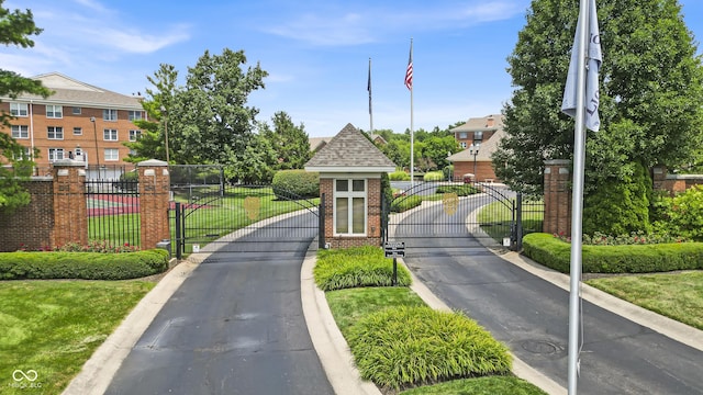 8650 Jaffa Ct W Drive 32, Indianapolis, IN 46260 - view of asphalt road featuring a gate, a gated entry, and curbs