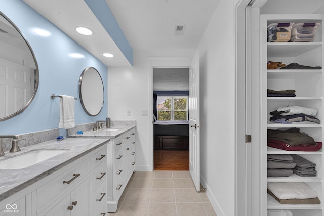 8650 Jaffa Ct W Drive 32, Indianapolis, IN 46260 - bathroom featuring double vanity, tile patterned flooring, recessed lighting, and a walk in closet