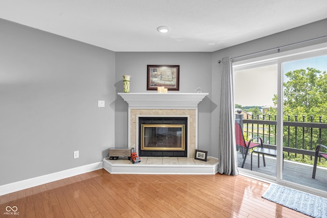 8650 Jaffa Ct W Drive 32, Indianapolis, IN 46260 - unfurnished living room with a tile fireplace, wood finished floors, and recessed lighting
