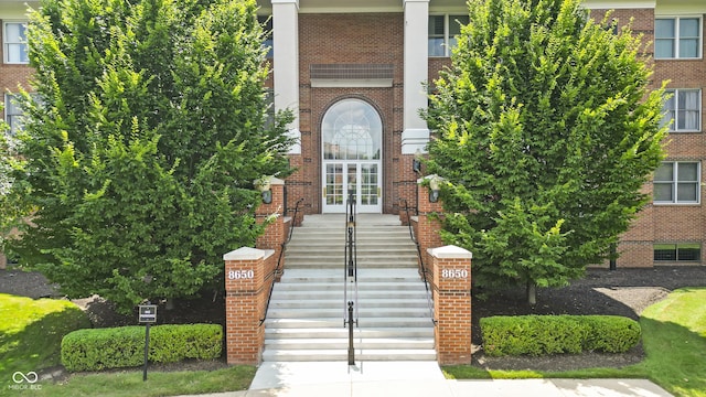 8650 Jaffa Ct W Drive 32, Indianapolis, IN 46260 - doorway to property with french doors and brick siding