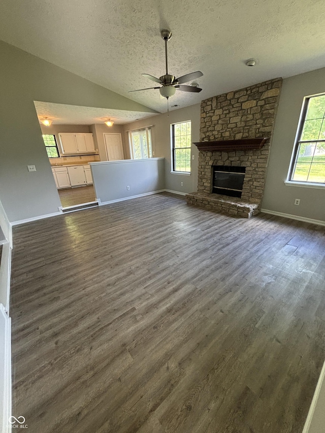 7313 Shanna Cir, Indianapolis, IN 46236 - unfurnished living room with a textured ceiling, healthy amount of natural light, dark wood-type flooring, ceiling fan, and lofted ceiling