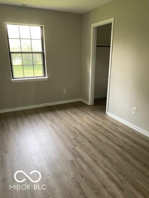 7313 Shanna Cir, Indianapolis, IN 46236 - unfurnished bedroom with wood finished floors and a closet