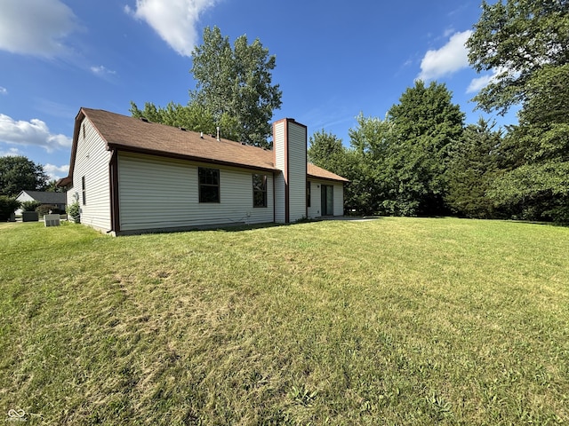 7313 Shanna Cir, Indianapolis, IN 46236 - back of house with a chimney and a lawn