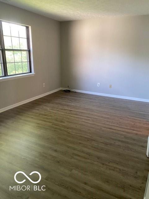 7313 Shanna Cir, Indianapolis, IN 46236 - spare room featuring dark wood-style flooring and baseboards