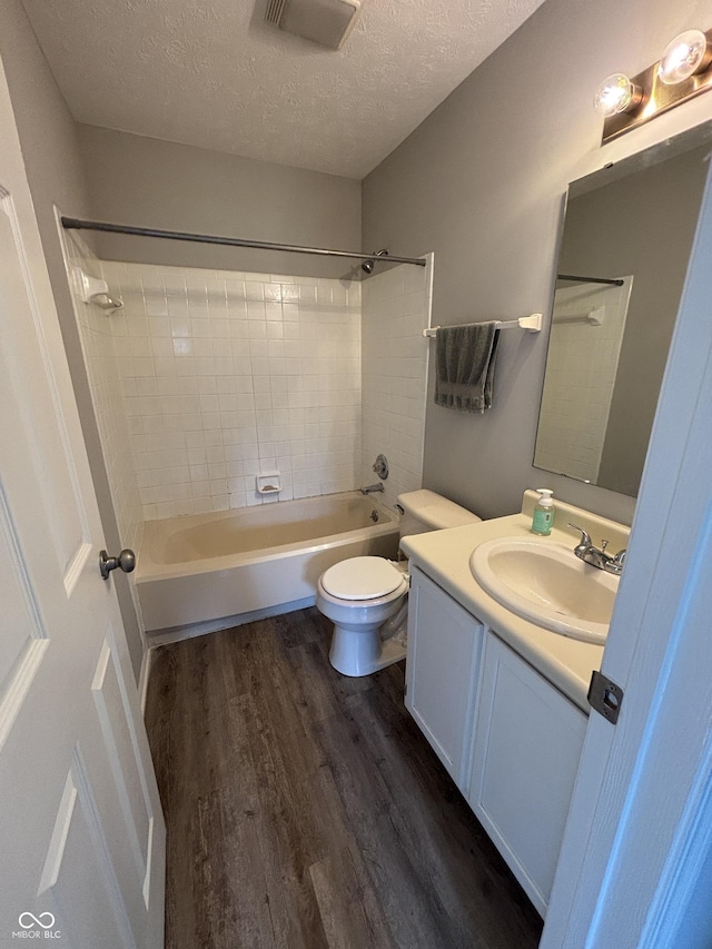 7313 Shanna Cir, Indianapolis, IN 46236 - bathroom with wood finished floors, vanity, washtub / shower combination, and a textured ceiling
