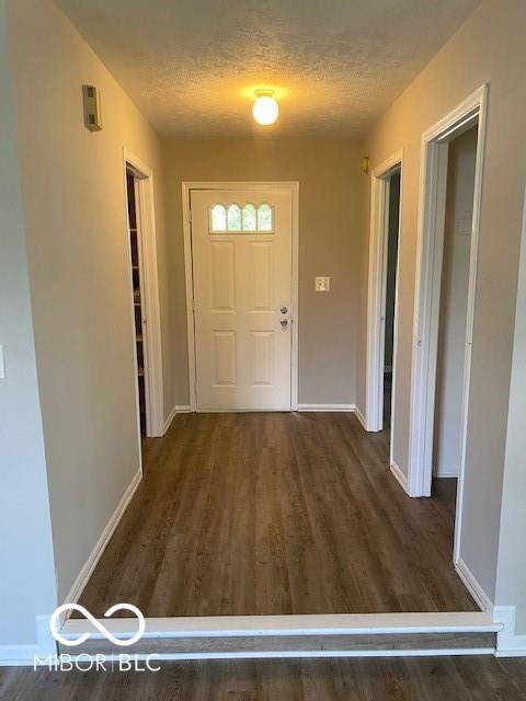 7313 Shanna Cir, Indianapolis, IN 46236 - entryway with dark wood-type flooring and a textured ceiling