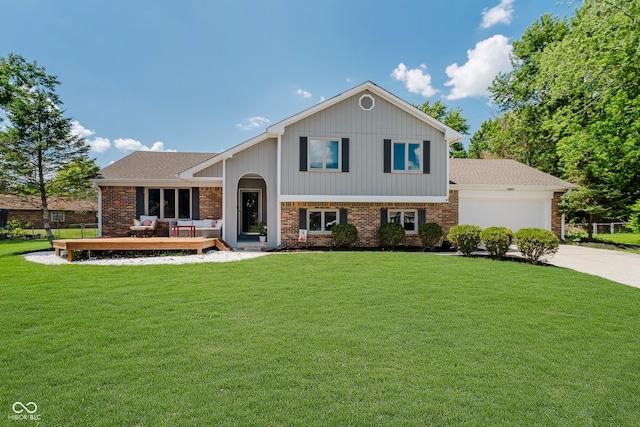 1616 Beech Cir, Plainfield, IN 46168 - tri-level home featuring concrete driveway, a garage, a front yard, a deck, and brick siding