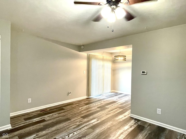 4933 Oakwood Trl, Indianapolis, IN 46268 - spare room with dark wood-style floors and ceiling fan