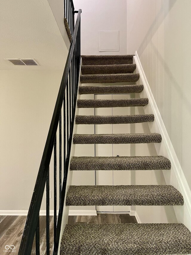 4933 Oakwood Trl, Indianapolis, IN 46268 - staircase with wood finished floors