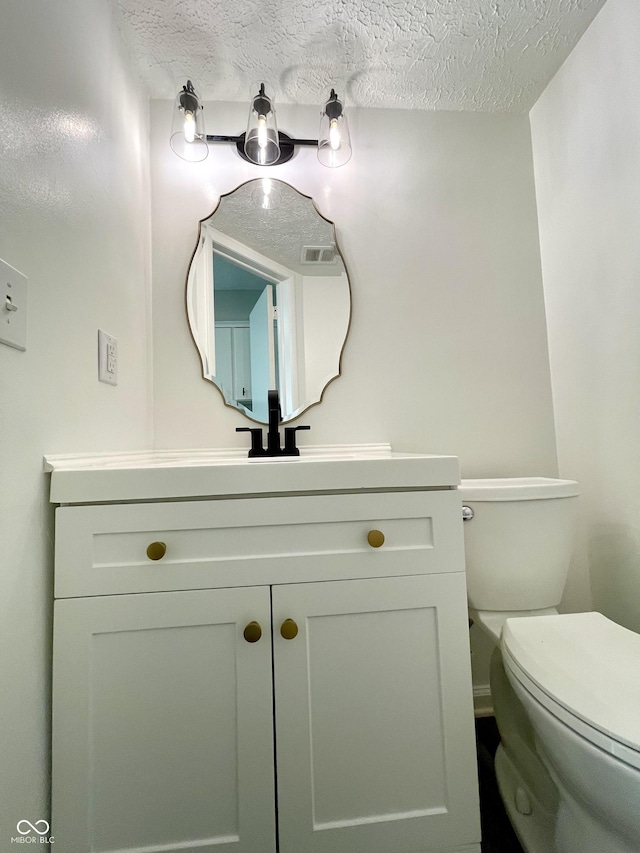 4933 Oakwood Trl, Indianapolis, IN 46268 - half bath featuring vanity and a textured ceiling