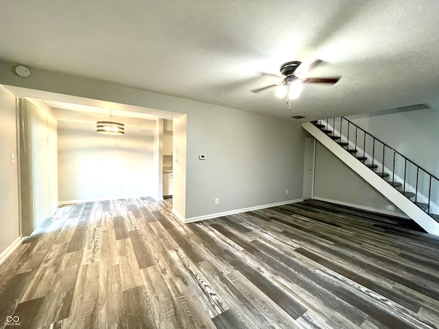 4933 Oakwood Trl, Indianapolis, IN 46268 - unfurnished living room featuring wood finished floors, stairway, ceiling fan, and a textured ceiling