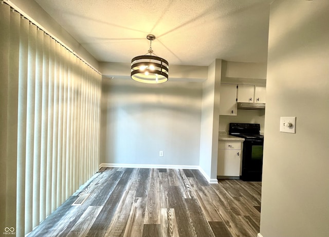 4933 Oakwood Trl, Indianapolis, IN 46268 - unfurnished dining area featuring dark wood-type flooring, a textured ceiling, and a chandelier
