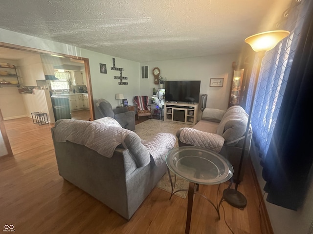 9783 Lee Ct, Columbus, IN 47203 - living room featuring a textured ceiling and wood finished floors