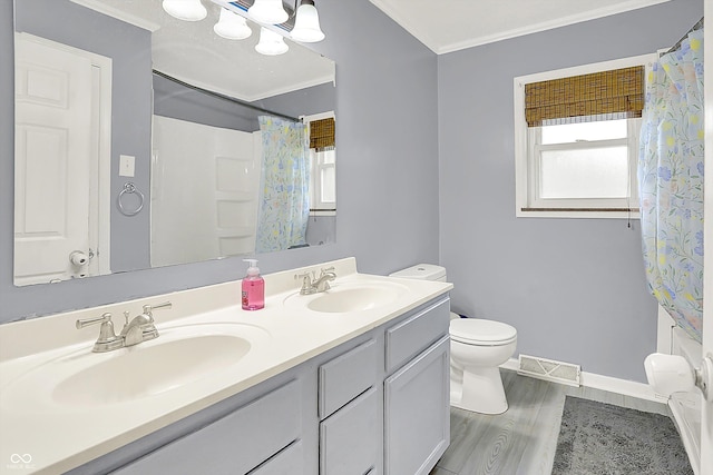125 E Waterbury Rd, Indianapolis, IN 46227 - bathroom featuring wood finished floors, double vanity, crown molding, and a shower with curtain