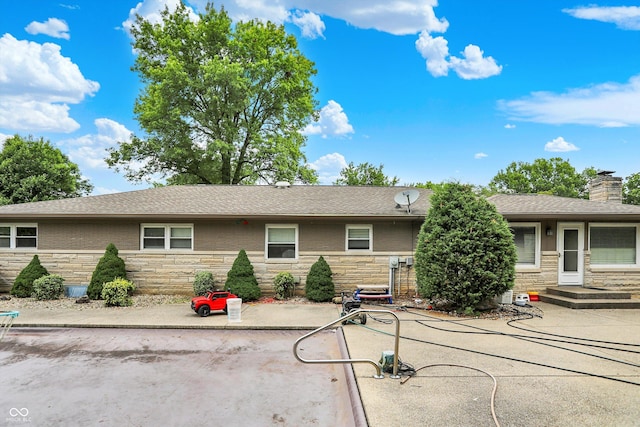 125 E Waterbury Rd, Indianapolis, IN 46227 - ranch-style home with stone siding, a patio area, and a chimney