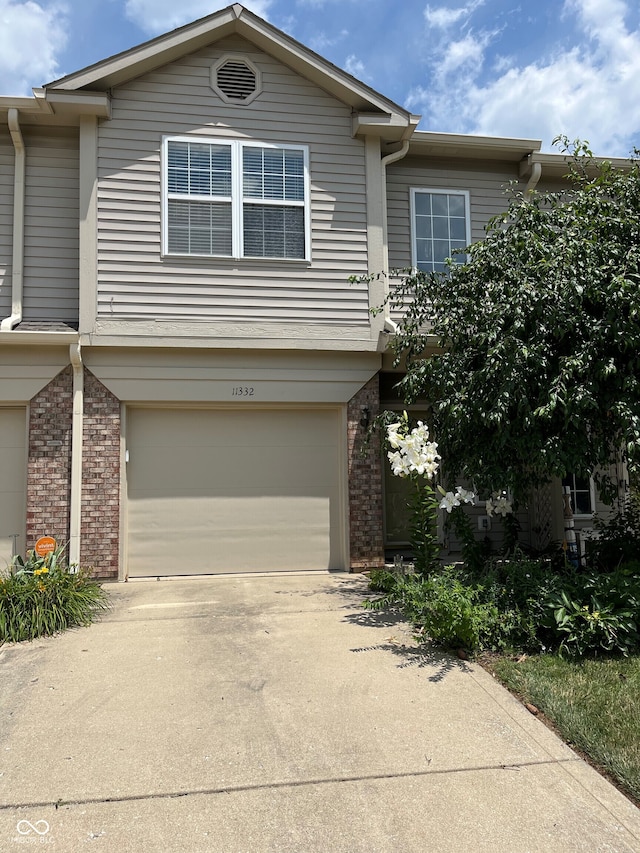 11332 Fonthill Dr, Indianapolis, IN 46236 - view of property featuring brick siding, an attached garage, and driveway