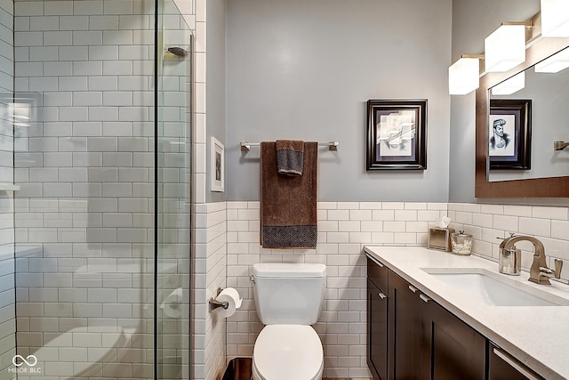 1551 N Park Ave, Indianapolis, IN 46202 - bathroom with vanity, a stall shower, tile walls, and wainscoting